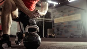 Photo of man chalking hands ready for kettlebell