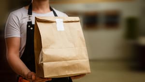Photo of a man holding a takeout bag
