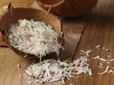 Photo of opened coconut with shredded coconut inside