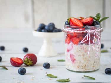 Photo of glass jar filled with overnight oats made with Growli Muesli, yoghurt and fruit