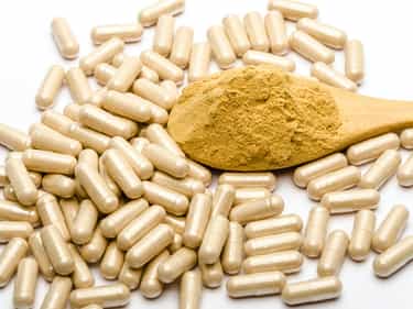 Photo of multivitamin capsules spilled on a white surface