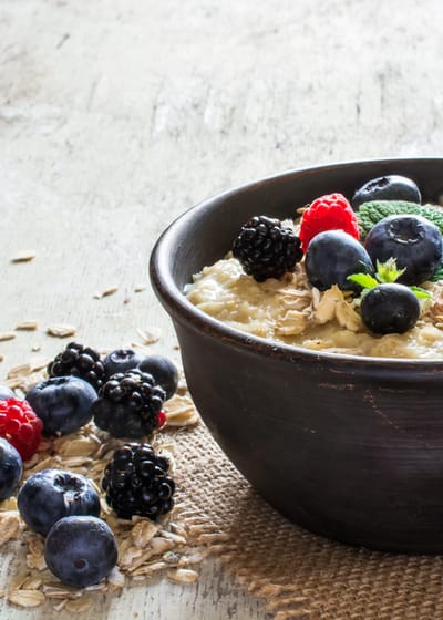Photo of a bowl of protein porridge oats with blue berries