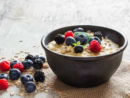 Photo of a bowl of protein porridge oats with blue berries