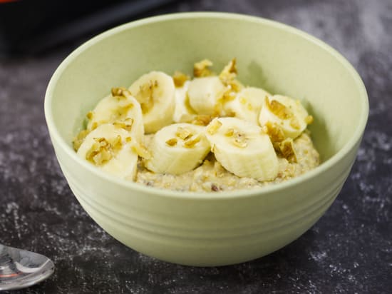 Photo of bowl of Growli Muesli with sliced banana, chopped walnuts, pinch cinnamon and spray cream