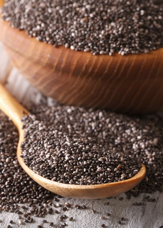 Photo of wooden bowl and spoon filled with chia seeds