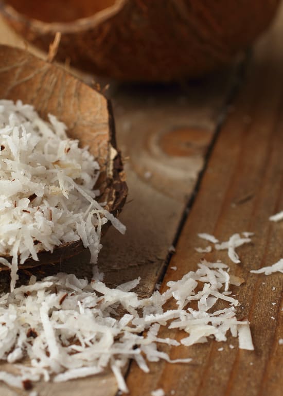 Photo of opened coconut with shredded coconut inside