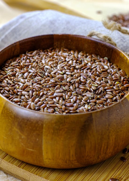 Photo of wooden bowl filled with whole flaxseed