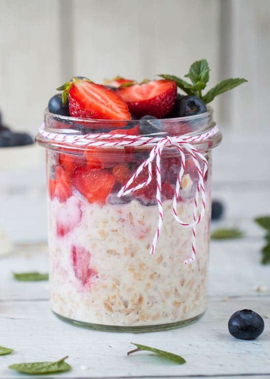 Photo of glass jar filled with overnight oats made with Growli Muesli, yoghurt and fruit