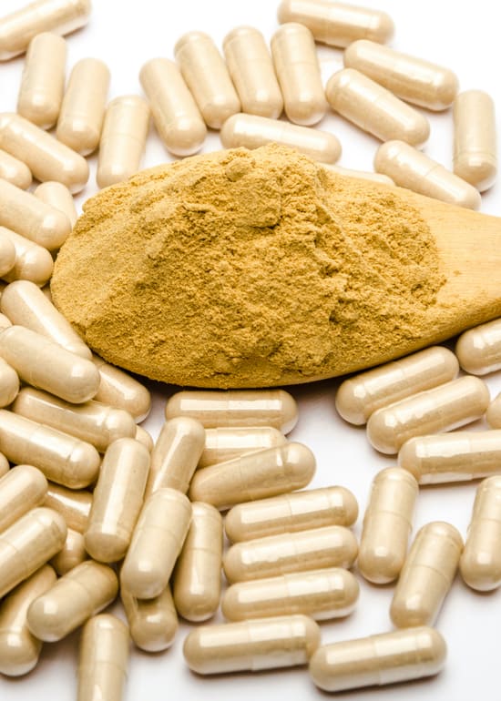 Photo of multivitamin capsules spilled on a white surface